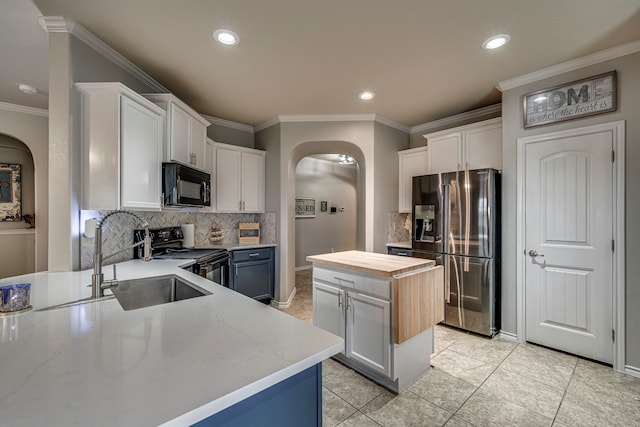 kitchen featuring a kitchen island, black appliances, and white cabinets