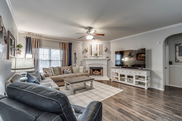 living room with hardwood / wood-style flooring, ceiling fan, and ornamental molding