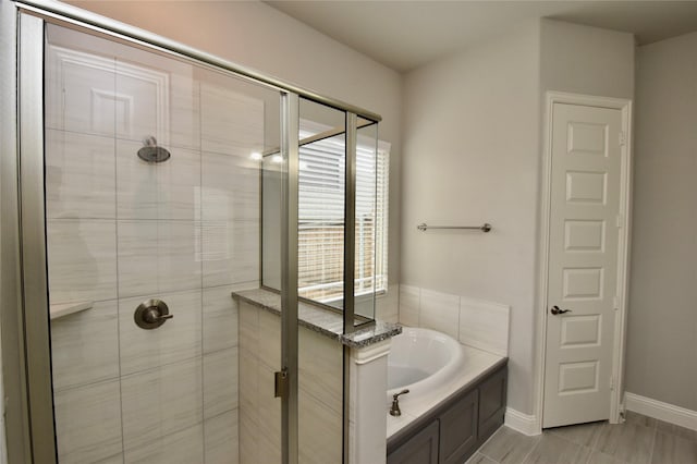 bathroom with separate shower and tub