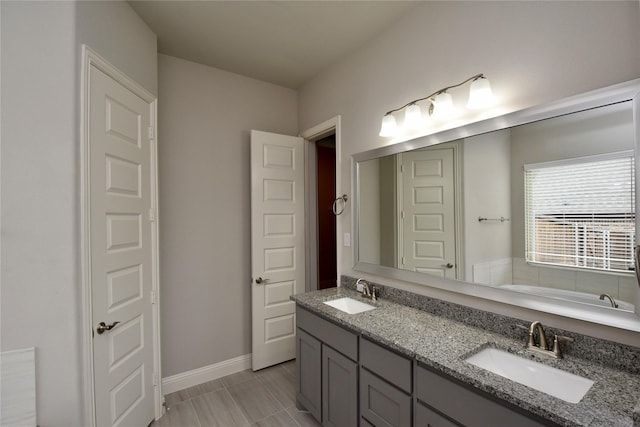 bathroom featuring a tub to relax in and vanity