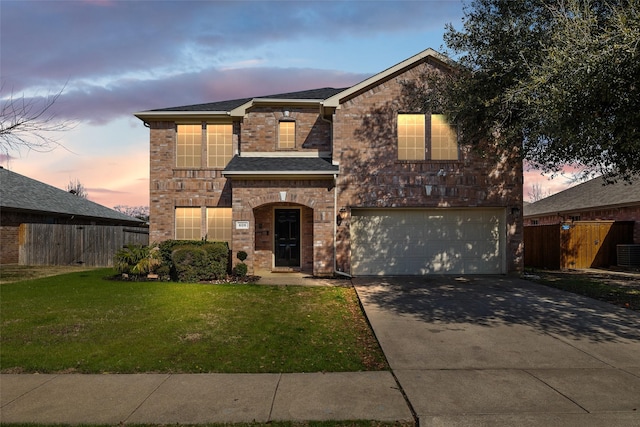 view of front property featuring a garage, central AC unit, and a lawn