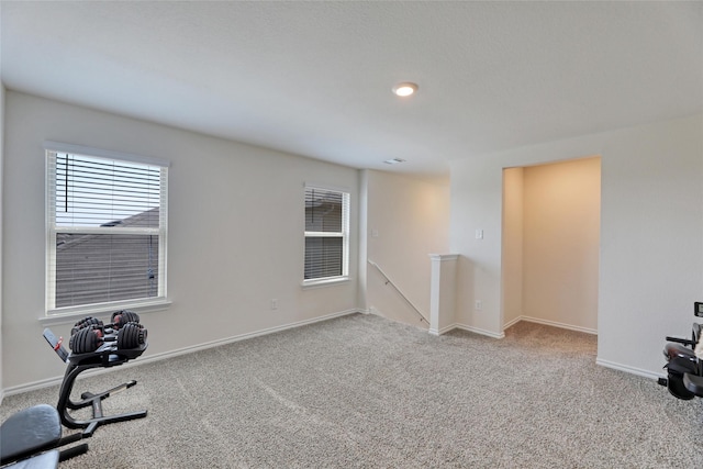 exercise area featuring light colored carpet