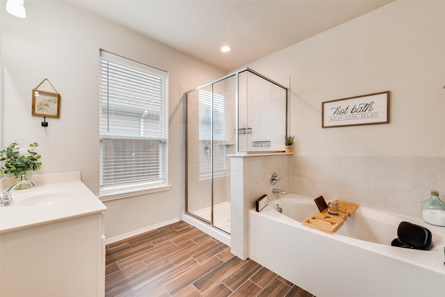 bathroom with vanity, recessed lighting, wood finish floors, a shower stall, and a bath