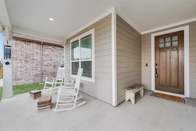 view of exterior entry with covered porch