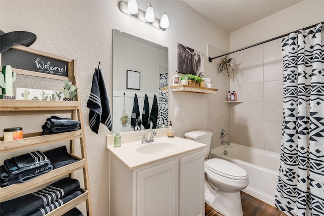 full bath featuring vanity, toilet, a textured wall, shower / bath combo, and wood finished floors