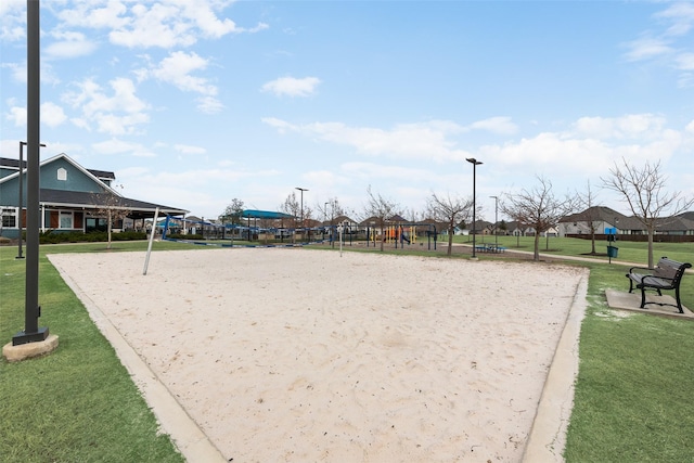 surrounding community with a lawn, playground community, and volleyball court