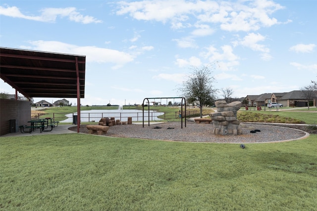 view of yard featuring playground community and fence