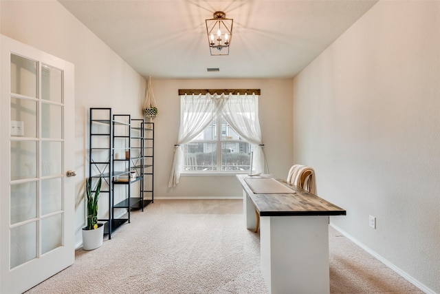 carpeted office with baseboards and visible vents