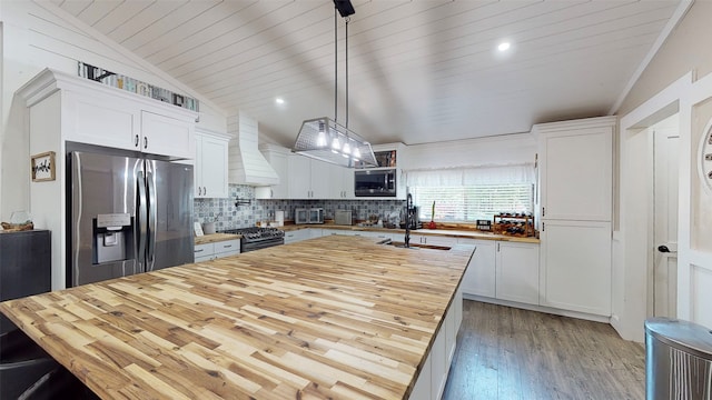1004 Rs County Road 3345, Emory, TX 75440 - kitchen featuring pendant lighting, sink, appliances with stainless steel finishes, custom range hood, and white cabinets
