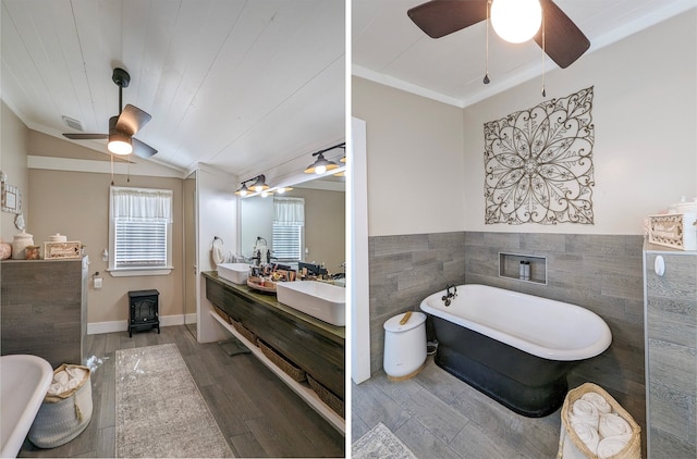 1004 Rs County Road 3345, Emory, TX 75440 - bathroom with hardwood / wood-style flooring, vanity, vaulted ceiling, a tub, and a wood stove