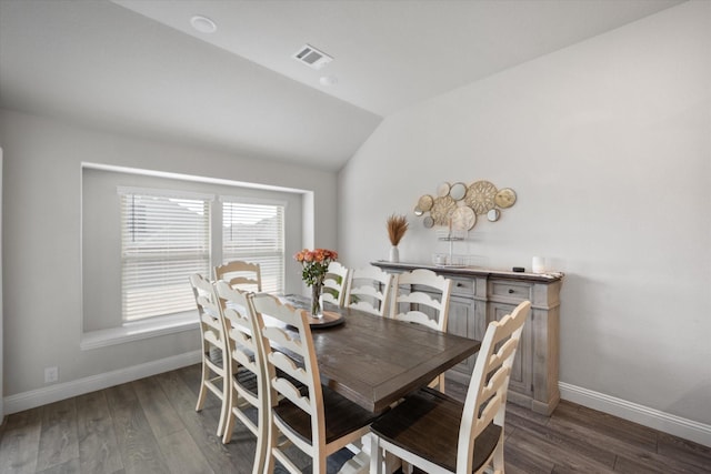 dining area with dark hardwood / wood-style flooring and lofted ceiling