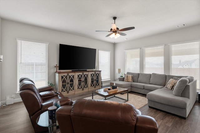 living room featuring ceiling fan and dark hardwood / wood-style flooring