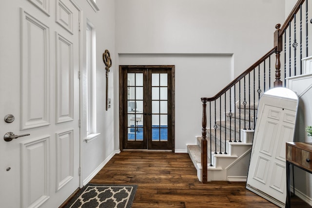 entryway featuring dark wood finished floors, stairway, french doors, and baseboards