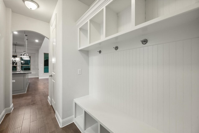 5204 Basham Ln, Mckinney, TX 75070 - mudroom featuring arched walkways, dark wood-style flooring, and a sink