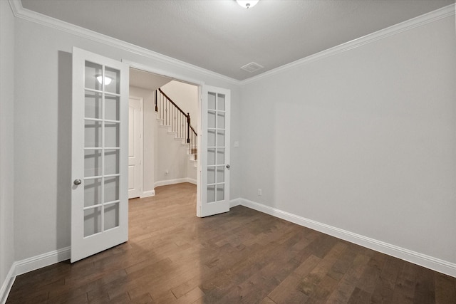5204 Basham Ln, Mckinney, TX 75070 - spare room featuring french doors, ornamental molding, baseboards, dark wood-style flooring, and stairs