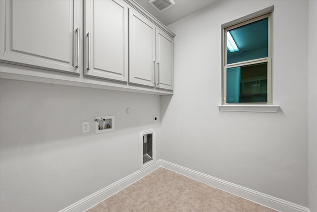 washroom with cabinets, hookup for a gas dryer, light colored carpet, hookup for a washing machine, and electric dryer hookup