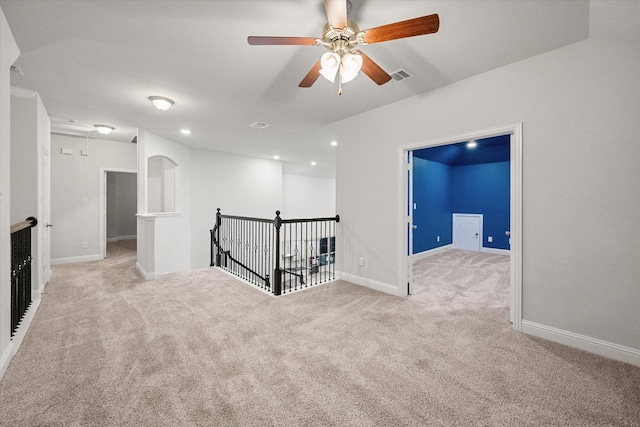 carpeted spare room with ceiling fan