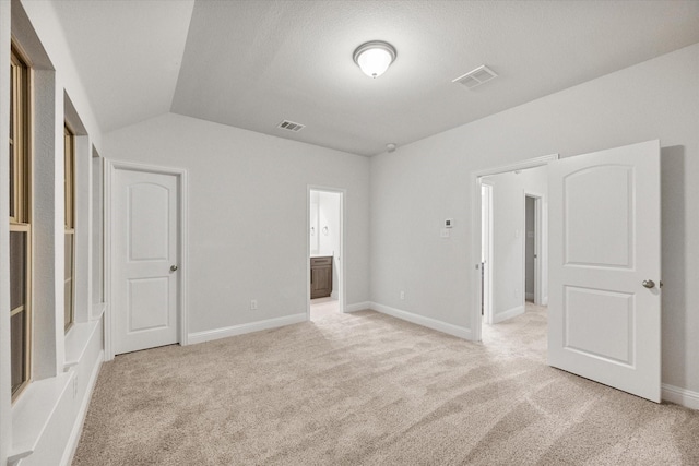 5204 Basham Ln, Mckinney, TX 75070 - unfurnished bedroom featuring vaulted ceiling, light carpet, baseboards, and ensuite bathroom