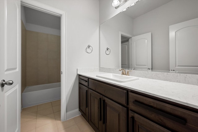 bathroom featuring tiled shower / bath, vanity, and tile patterned flooring