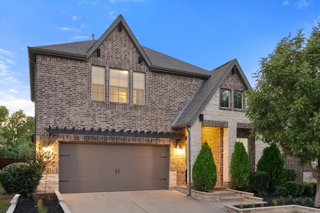 5204 Basham Ln, Mckinney, TX 75070 - view of front of house with brick siding, an attached garage, roof with shingles, and stone siding
