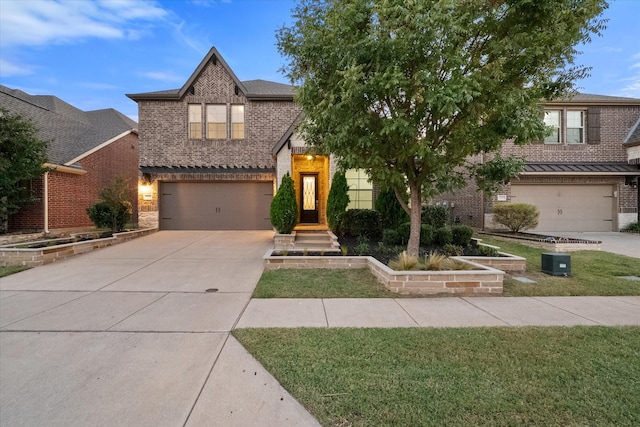 view of front facade with a garage and a front lawn