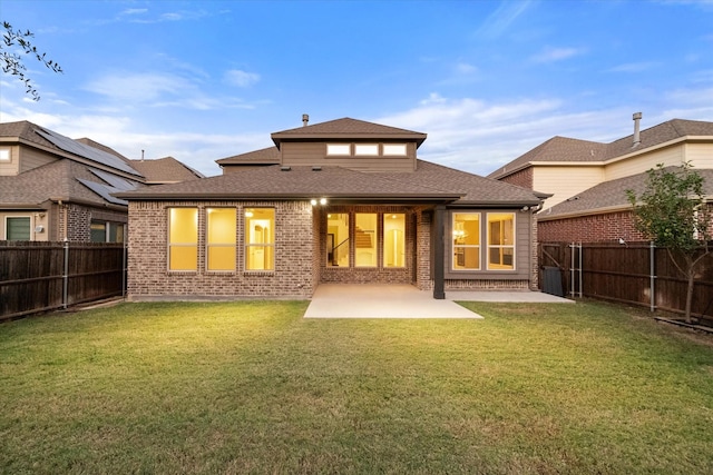 back of property with a patio and a lawn