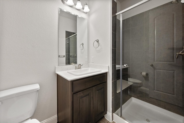 bathroom featuring vanity, toilet, and an enclosed shower