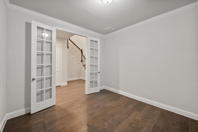 unfurnished room with hardwood / wood-style floors, crown molding, and french doors