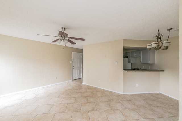 interior space featuring ceiling fan with notable chandelier