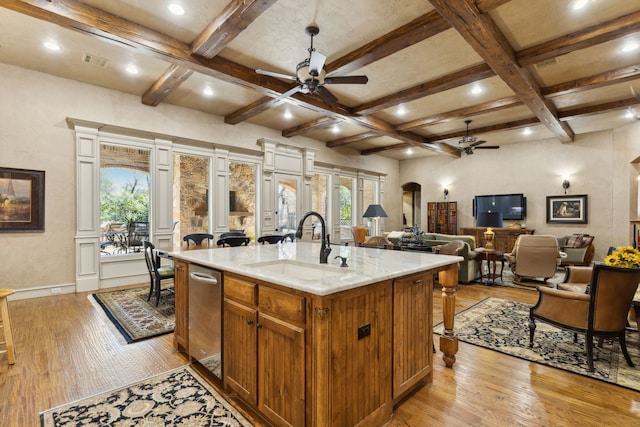 kitchen featuring a ceiling fan, arched walkways, beam ceiling, and coffered ceiling