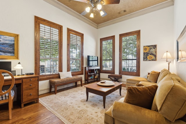 interior space with ceiling fan, ornamental molding, wood finished floors, and visible vents