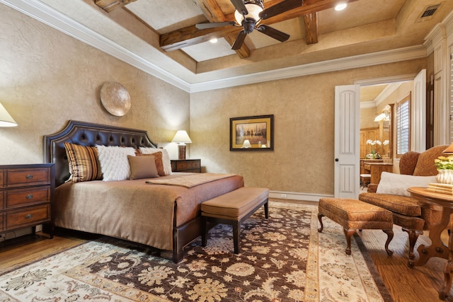 bedroom featuring beam ceiling, crown molding, visible vents, wood finished floors, and coffered ceiling