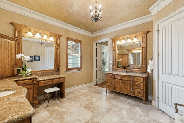 bathroom featuring two vanities, ornamental molding, a sink, a chandelier, and baseboards