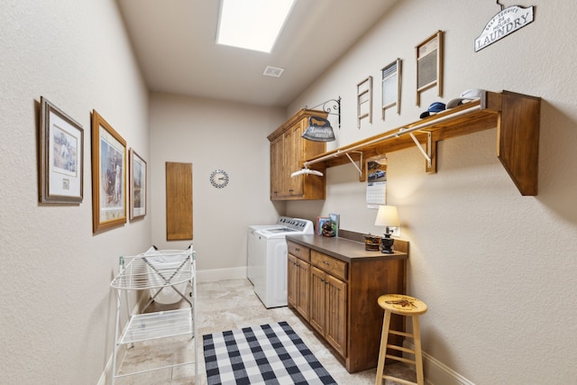 clothes washing area with cabinet space, washer and clothes dryer, and baseboards