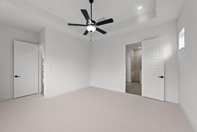 602 Lundy Ln, Mansfield, TX 76063 - unfurnished bedroom featuring light carpet, baseboards, recessed lighting, a tray ceiling, and a ceiling fan