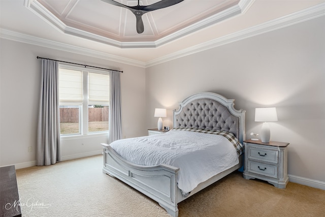 carpeted bedroom with crown molding and a raised ceiling