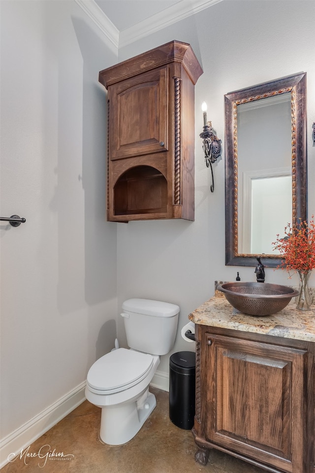 bathroom with ornamental molding, toilet, and vanity