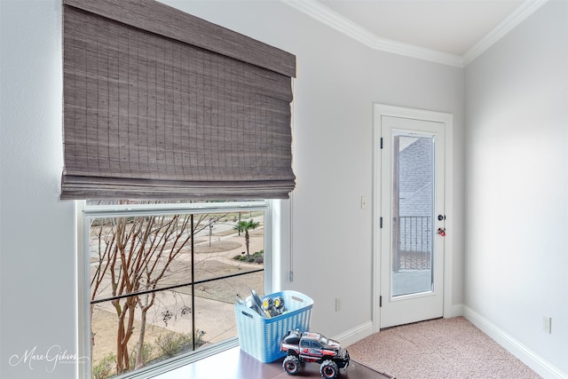 doorway to outside featuring ornamental molding, plenty of natural light, and carpet