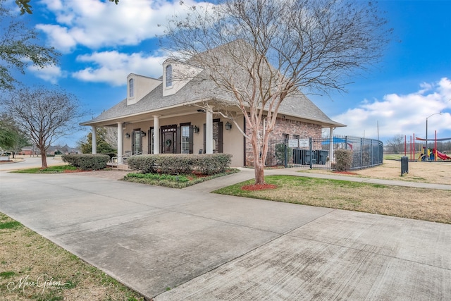 view of front of property featuring a playground and covered porch