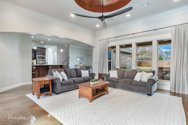 living room featuring crown molding and ceiling fan