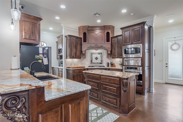 kitchen with stainless steel appliances, light stone countertops, sink, and dark brown cabinets