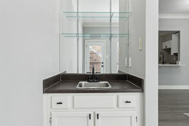 bathroom with hardwood / wood-style floors, vanity, and ornamental molding