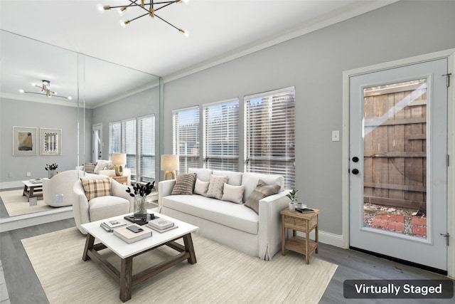 living room featuring hardwood / wood-style floors, a chandelier, and ornamental molding