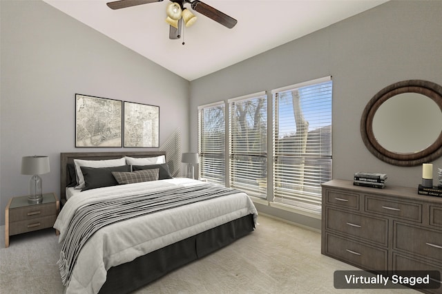 carpeted bedroom with ceiling fan and lofted ceiling