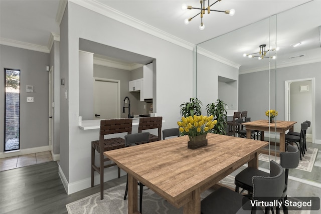 dining room featuring ornamental molding, a notable chandelier, and wood-type flooring