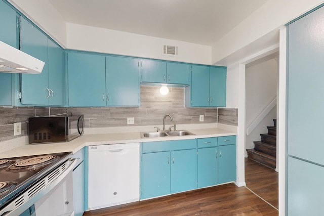 kitchen featuring blue cabinetry, light countertops, white dishwasher, a sink, and black microwave