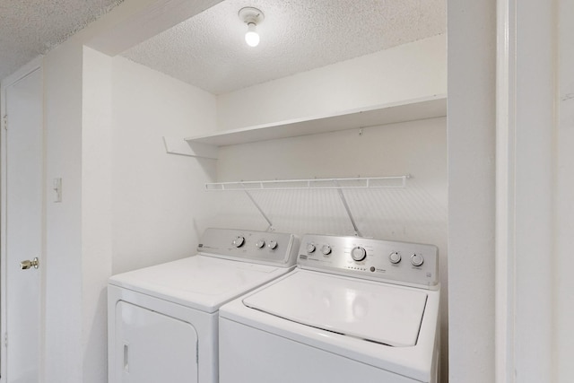 laundry area featuring laundry area, independent washer and dryer, and a textured ceiling