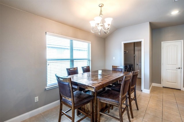 dining room featuring lofted ceiling, a chandelier, and light tile patterned flooring