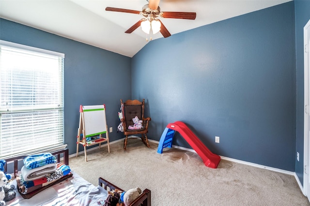 playroom with ceiling fan, lofted ceiling, and carpet flooring