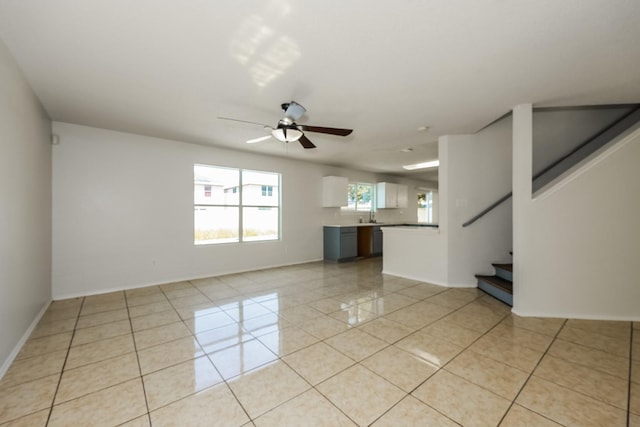 unfurnished living room with ceiling fan and light tile patterned floors